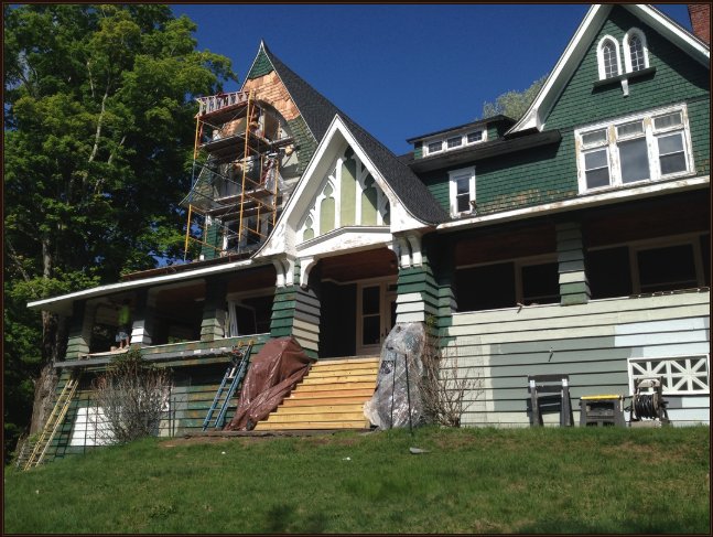 Historic Victorian home under restoration with scaffolding on the tower